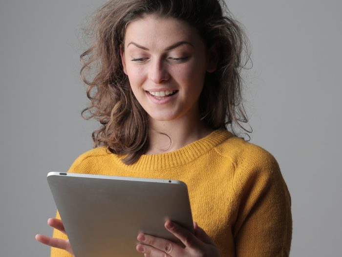 woman-in-yellow-sweater-holding-silver-ipad-3979198