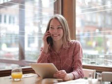 woman-in-pink-and-white-plaid-dress-shirt-sitting-at-table-3940338
